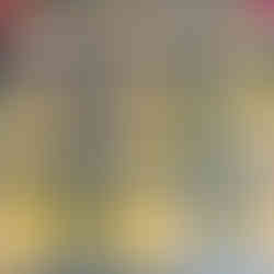 a muffin pan full of blended eggs with ham and cheese uncooked and ready to go into the oven