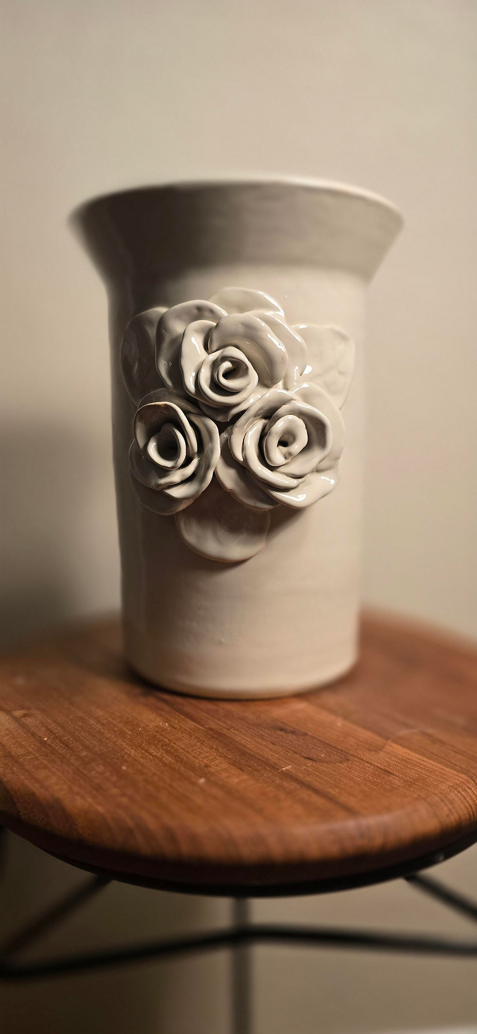 Thumbnail: Another view of the vintage white vase with more detail of the hand carved roses on the front.
