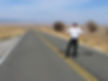 The author avoiding blowing tumbleweeds along Hwy 58