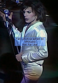 Glam rock queen Fairy Mercury in white satin live on stage.