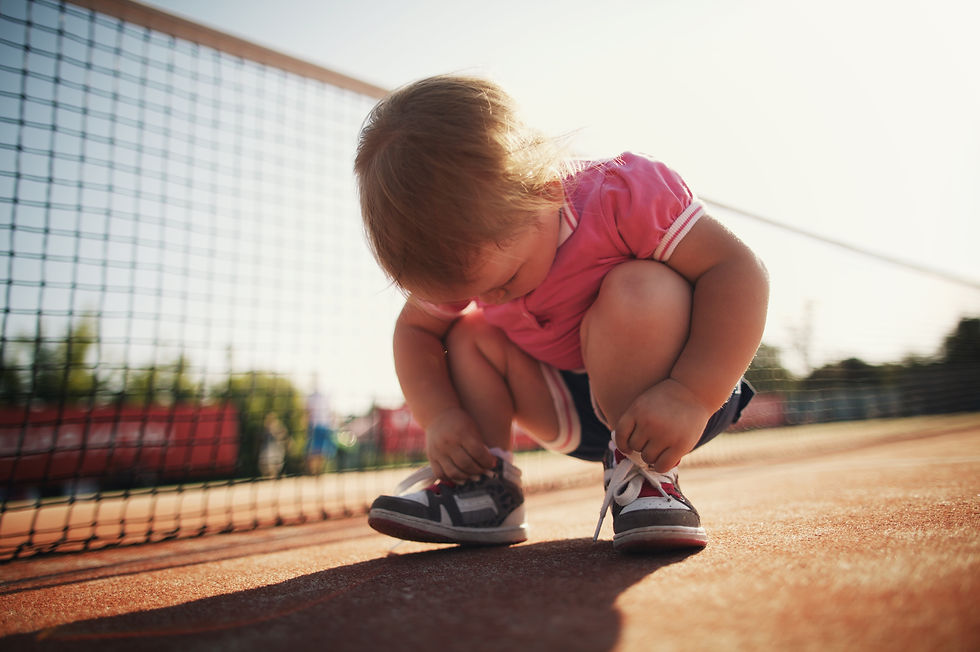 Child attempting to tie shoes