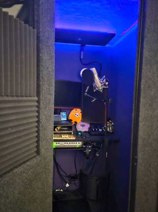 Inside the Session Booth Double Walled Series vocal booth, full PC access, two monitors, neumann microphone, preamp, interface, headphones and various bits of gear