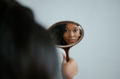 Woman with luxury wig looking in mirror