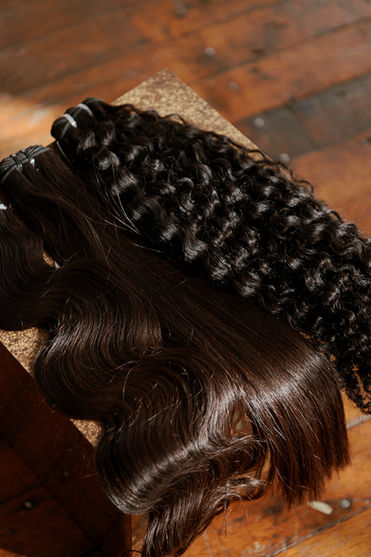 Two luxury hair bundles, one wavy and one curly