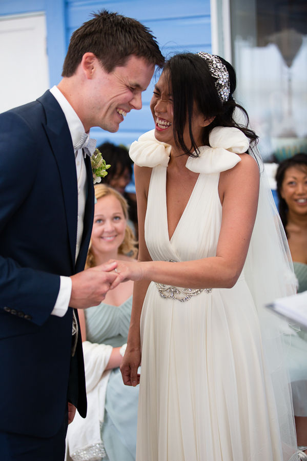 Bridesmaid smiles as Simon & Lien share a joke during their wedding ceremony.