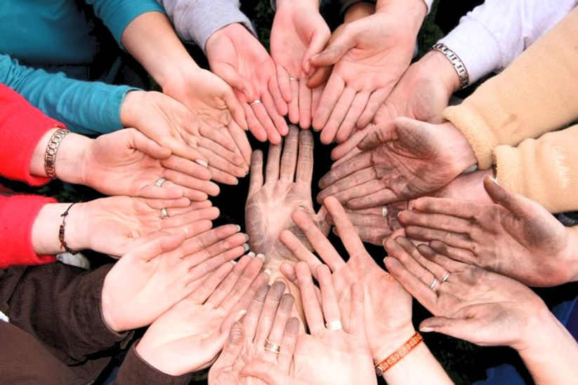 Many peoples hands making a circle