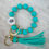 Thumbnail: Mama Needs Coffee - Teal Keychain Wristlet with Tassel