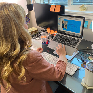 Woman sitting at the computer hosting a slide presentation
