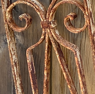 This is a metal garden trellis that has been rusted by the weather