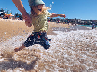 a young boy been thrown into the ocean's shore break