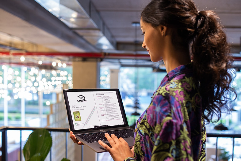 woman-working-with-macbook-mockup-standing-near-a-plant-a21176_edited.jpg