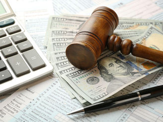 Calculator, gavel, and money symbolize new tax law impacts from the One Big Beautiful Bill, signed into law July 4