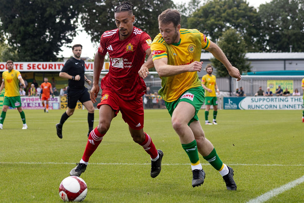 Man of the Match Sean Miller drives into the box under pressure from Clitheroe. Picture by PETER CANTWELL.