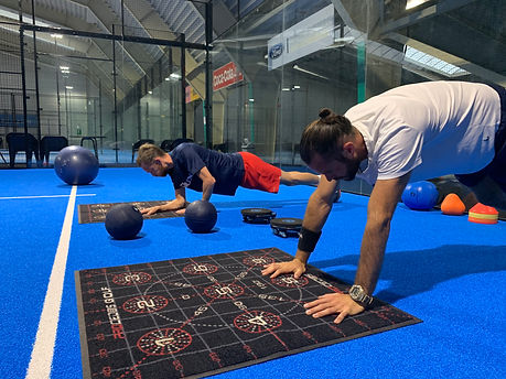 Men training indoors with functional equipment