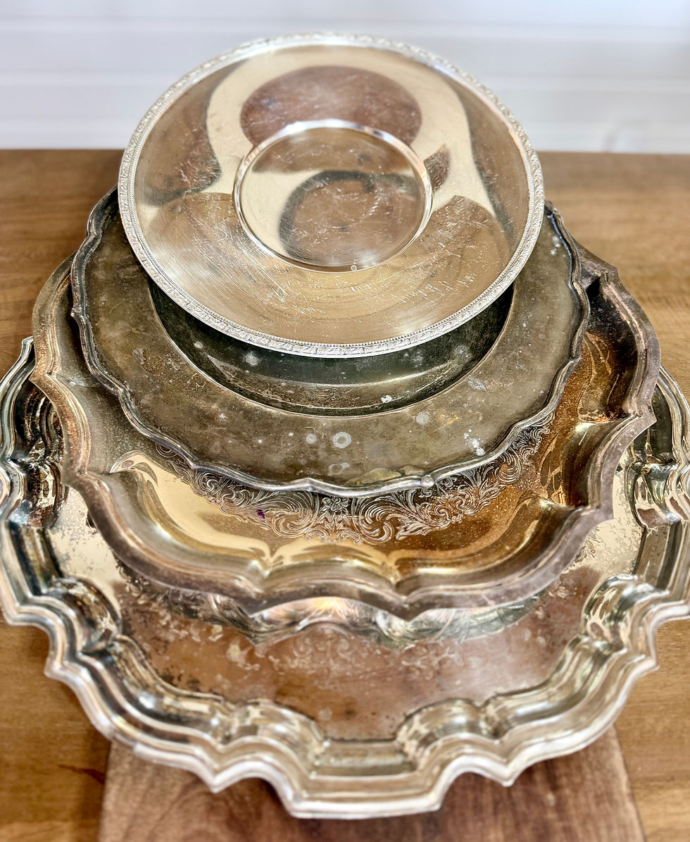 Three stacked ornate silver trays