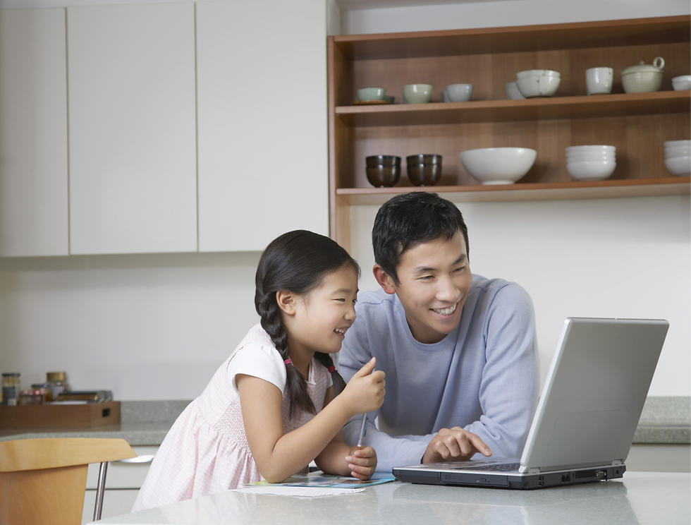 Dad and daughter working on laptop