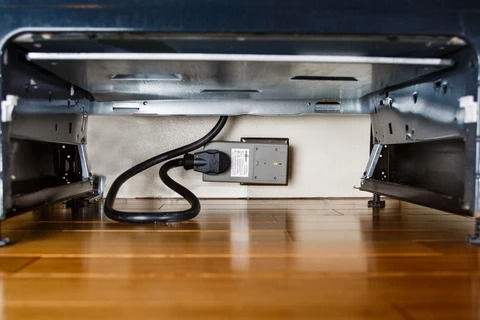 FireAvert's auto stove shutoff plugged in behind stove