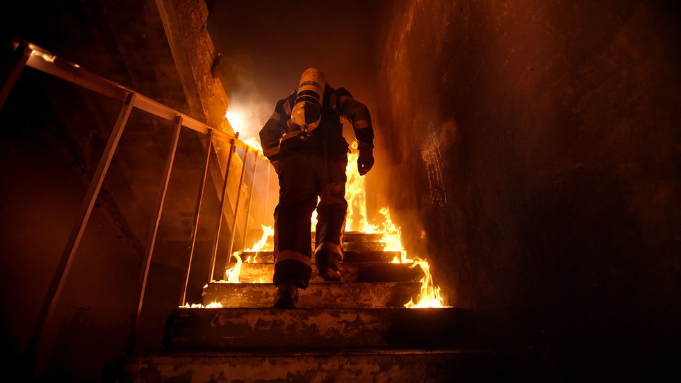 Fireman running upstairs into a fire