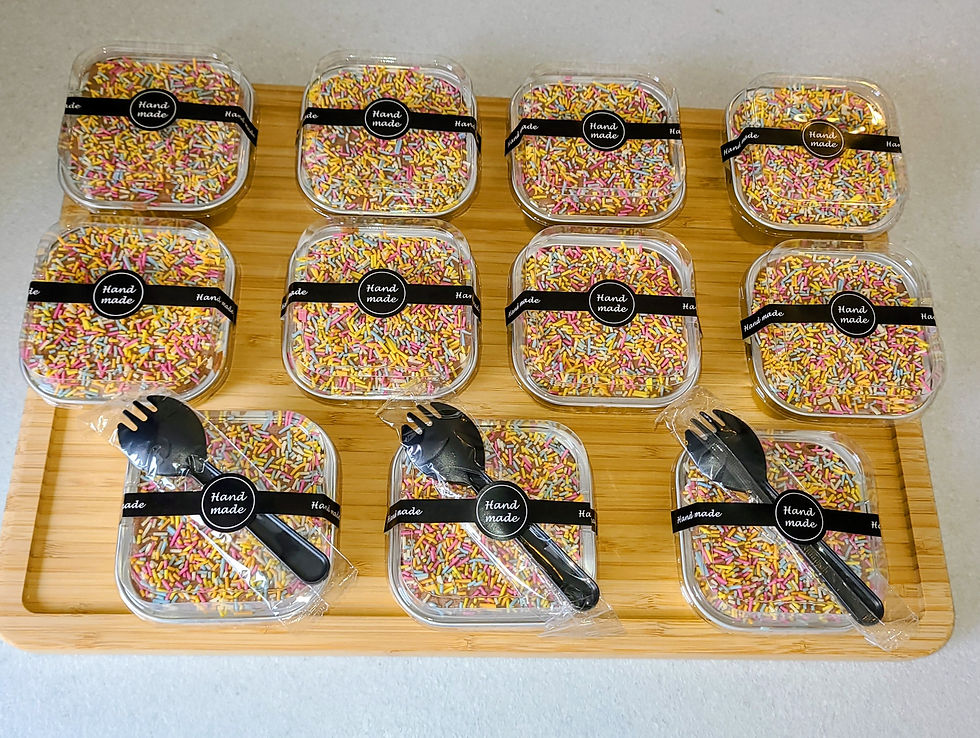 Eye-level view of a dessert box being opened to reveal assorted cakes
