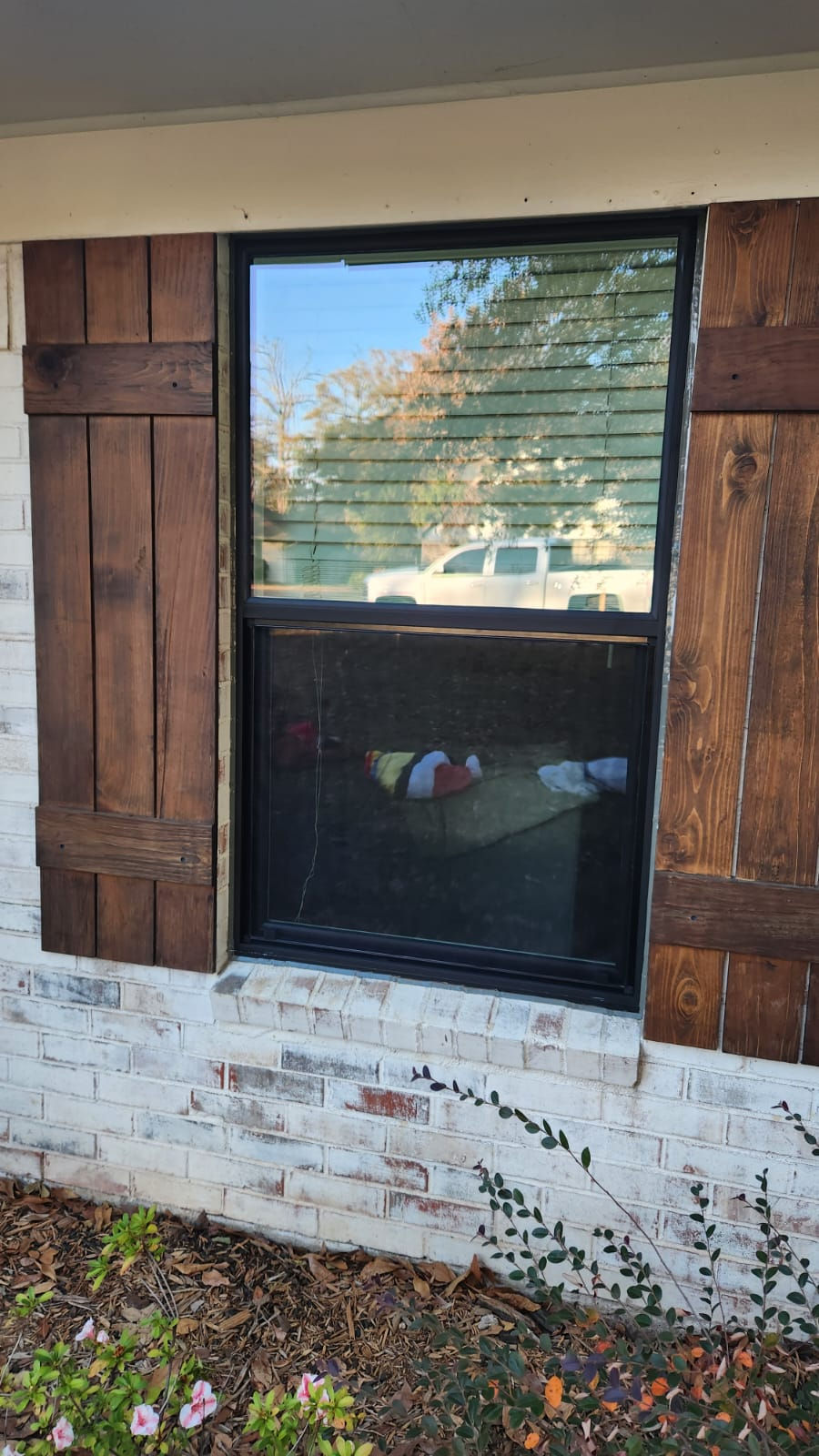 Residential window with dark wood shutters