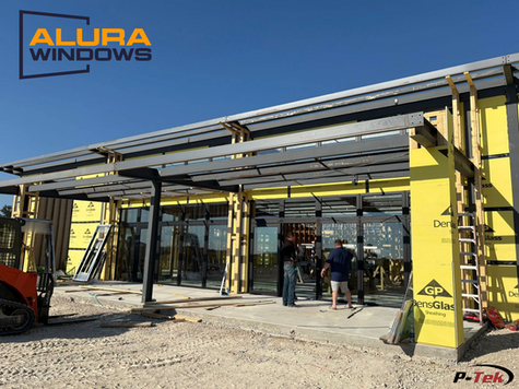 Commercial building under construction with installed Alura vinyl windows – P-Tek exclusive