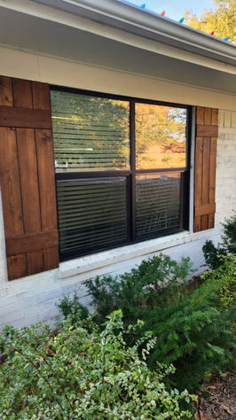 Residential window with dark wooden shutters