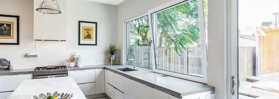 Modern kitchen, white cabinets, gray countertops, large Alura European Tilt and Turn Windows.