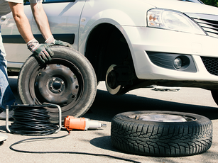 man-changing-car-tires-partial-view-with-spare-tire