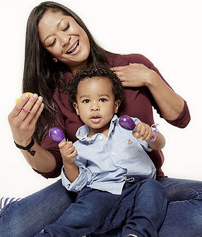 mother with toddler singing with rattles