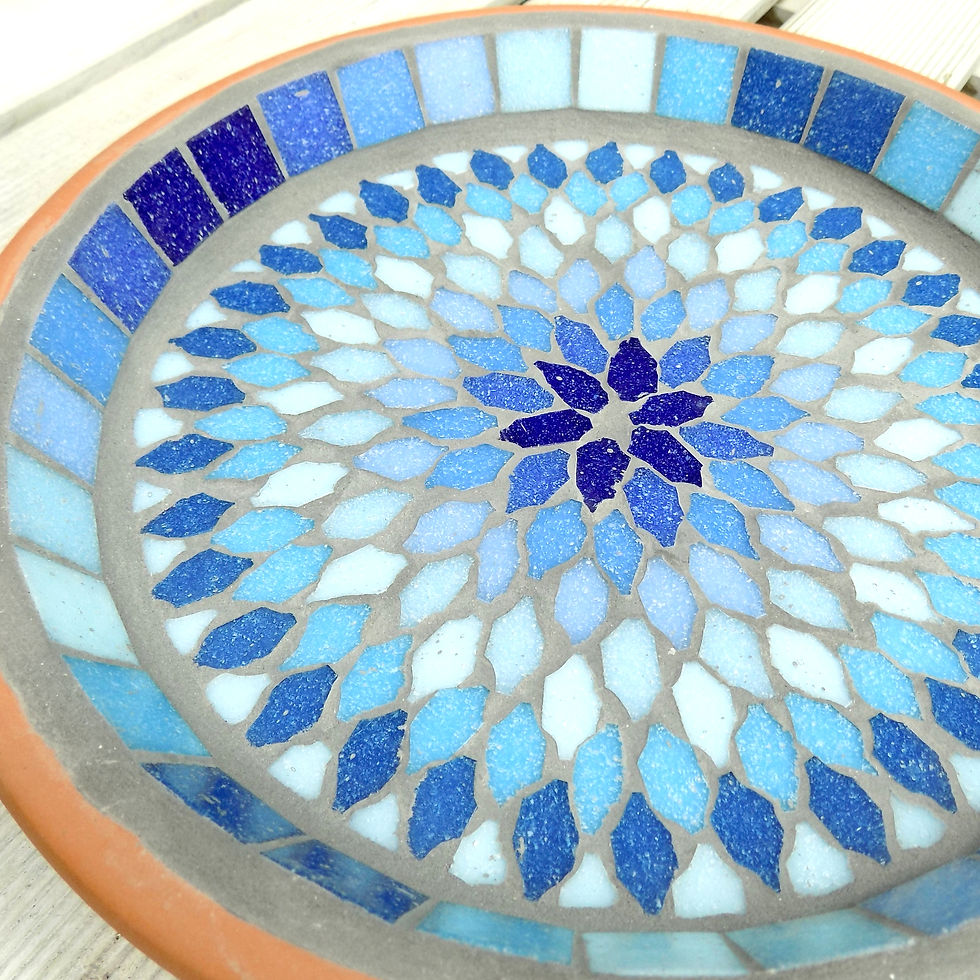 Thumbnail: A mosaic bird bath, in a terracotta garden saucer, with a bohemian mandala splash design in shades of blues and turquoises.