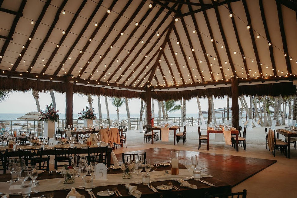 Gazebo 55 beach ceremony setup with white chairs and draped canopy