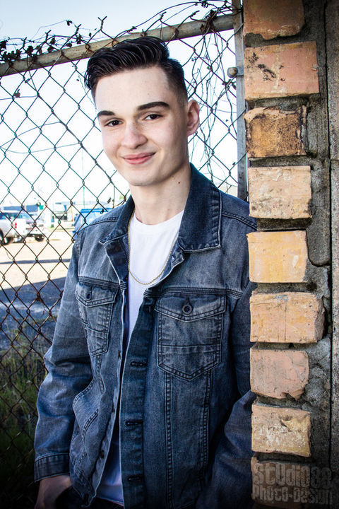 Portrait of a smiling young man in denim jacket
