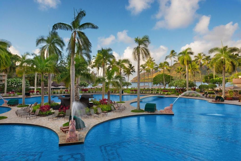 Palm-fringed outdoor pool at Marriott’s Kauai Beach Club at sunset