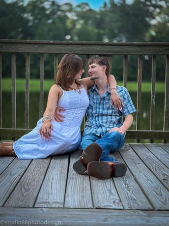 Couple sitting together outdoors beside a lake