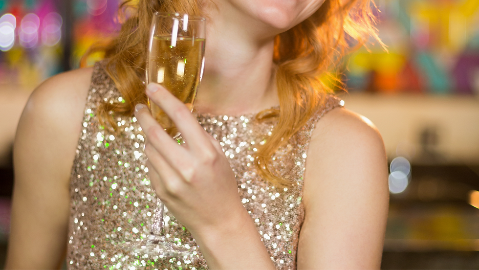 Close-up of a woman in a sparkling gold dress holding a glass of champagne, symbolizing luxury nightlife in Las Vegas.