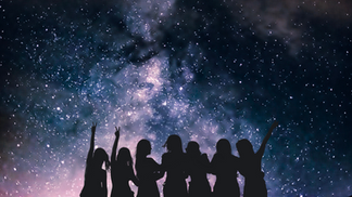 Silhouette of a woman under a clear night sky in the mountains, arms lifted in quiet celebration and spiritual connection with nature.