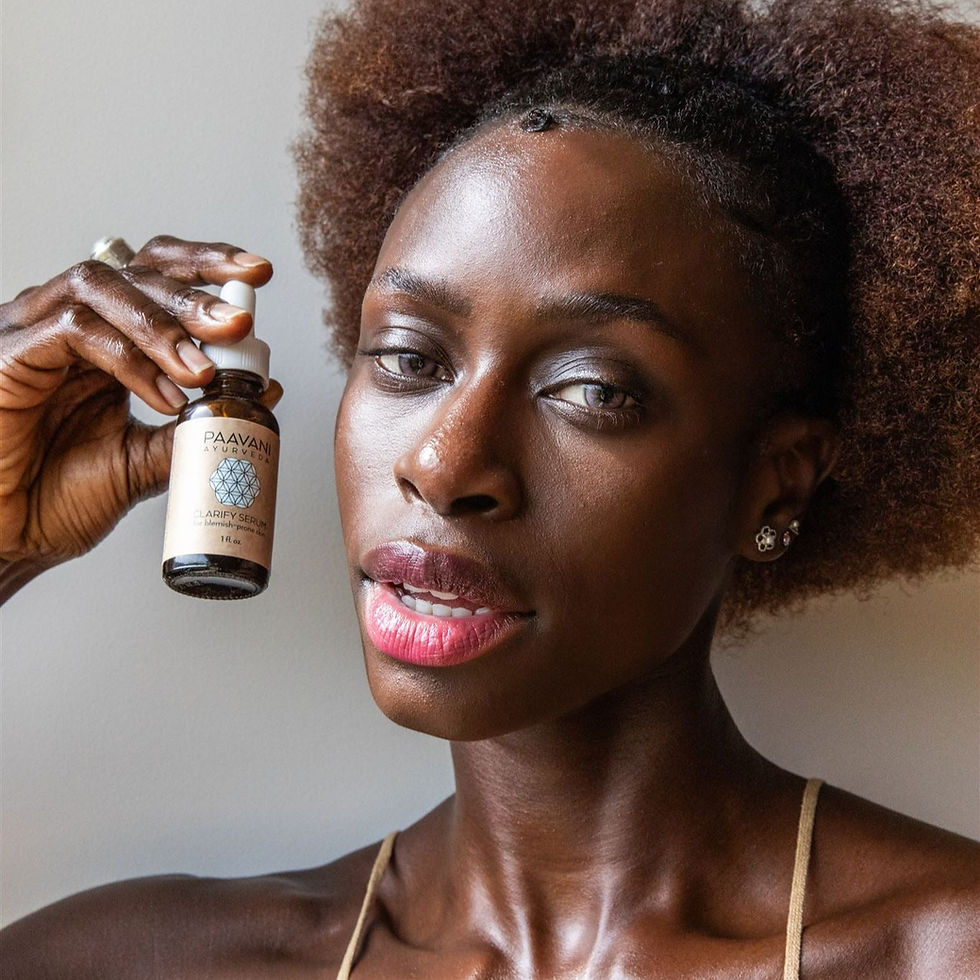 Woman holding small serum bottle
