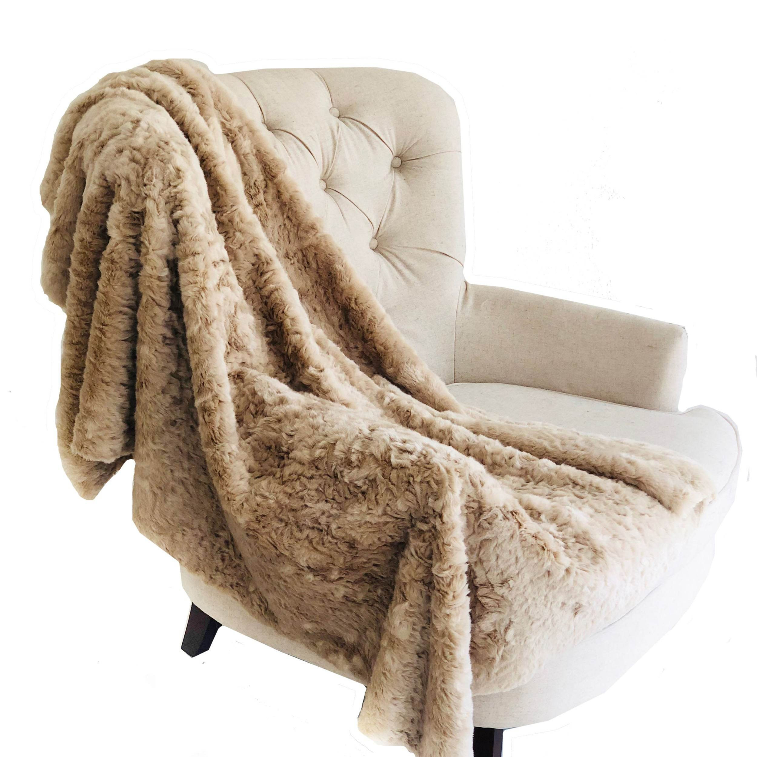 Beige furry blanket draped over an armchair