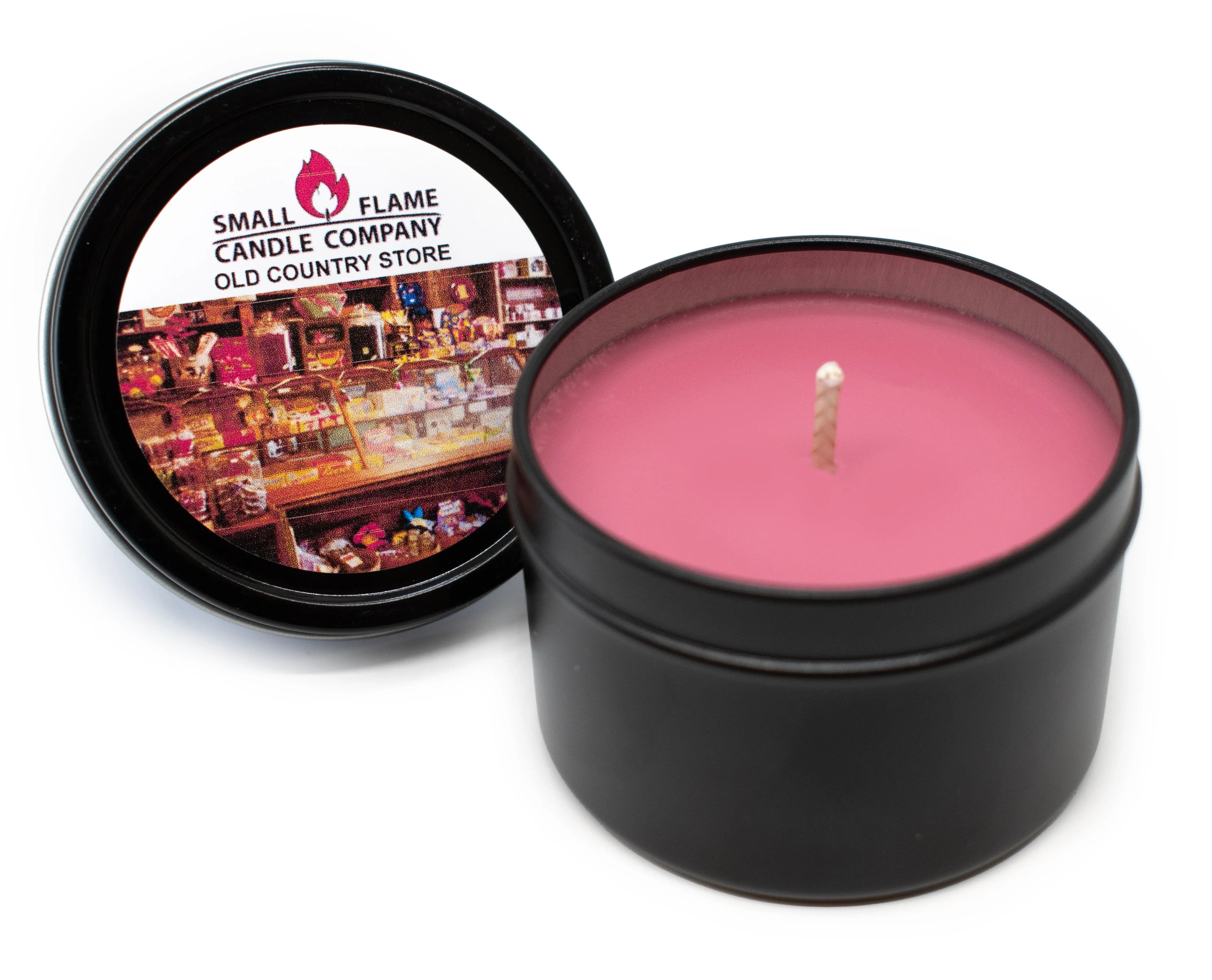 Open black tin with pink candle, 'Small Flame Candle Company' on lid.