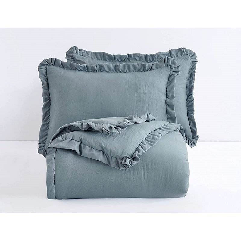 Blue-grey bedding set with ruffled pillows and comforter
