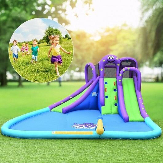 Inflatable water park with slides, climbing wall, and pool