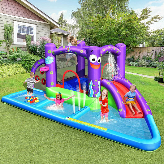 Children playing on a purple inflatable water slide castle