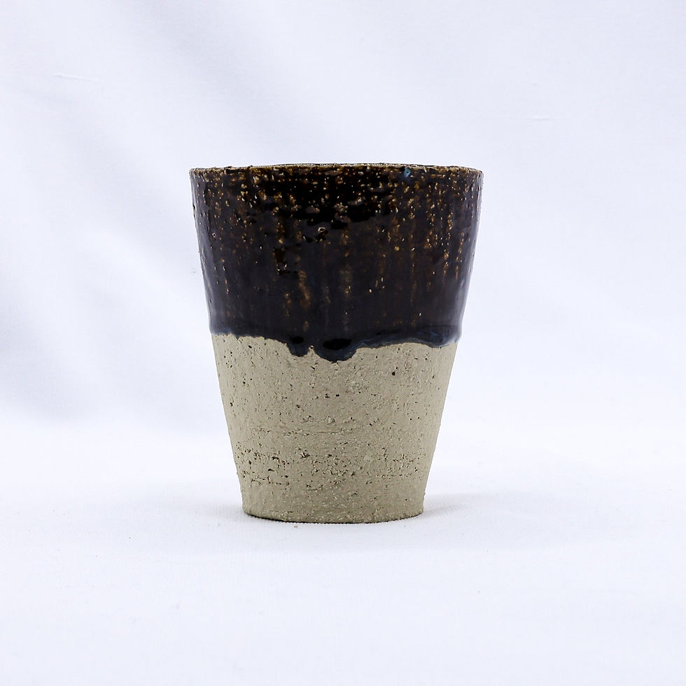 Two-tone ceramic cup, dark brown glaze over speckled beige