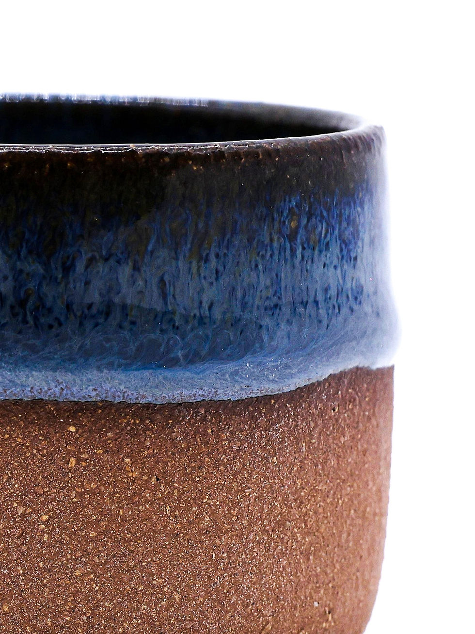 Close-up of a mug with dark blue glaze and brown textured body