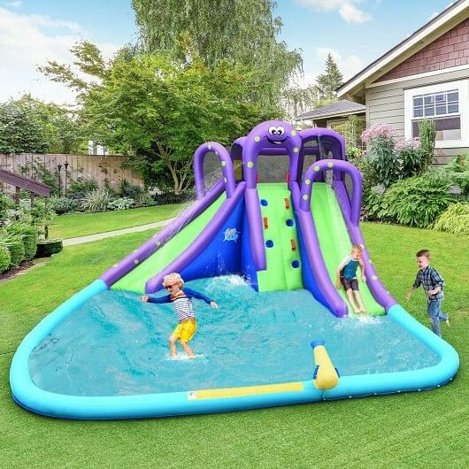 Inflatable backyard water slide with two kids playing