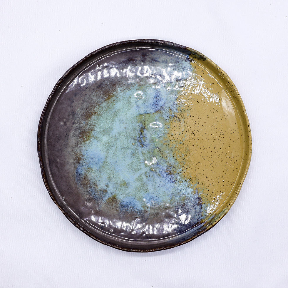Ceramic plate with artistic blue, brown, and yellow glaze