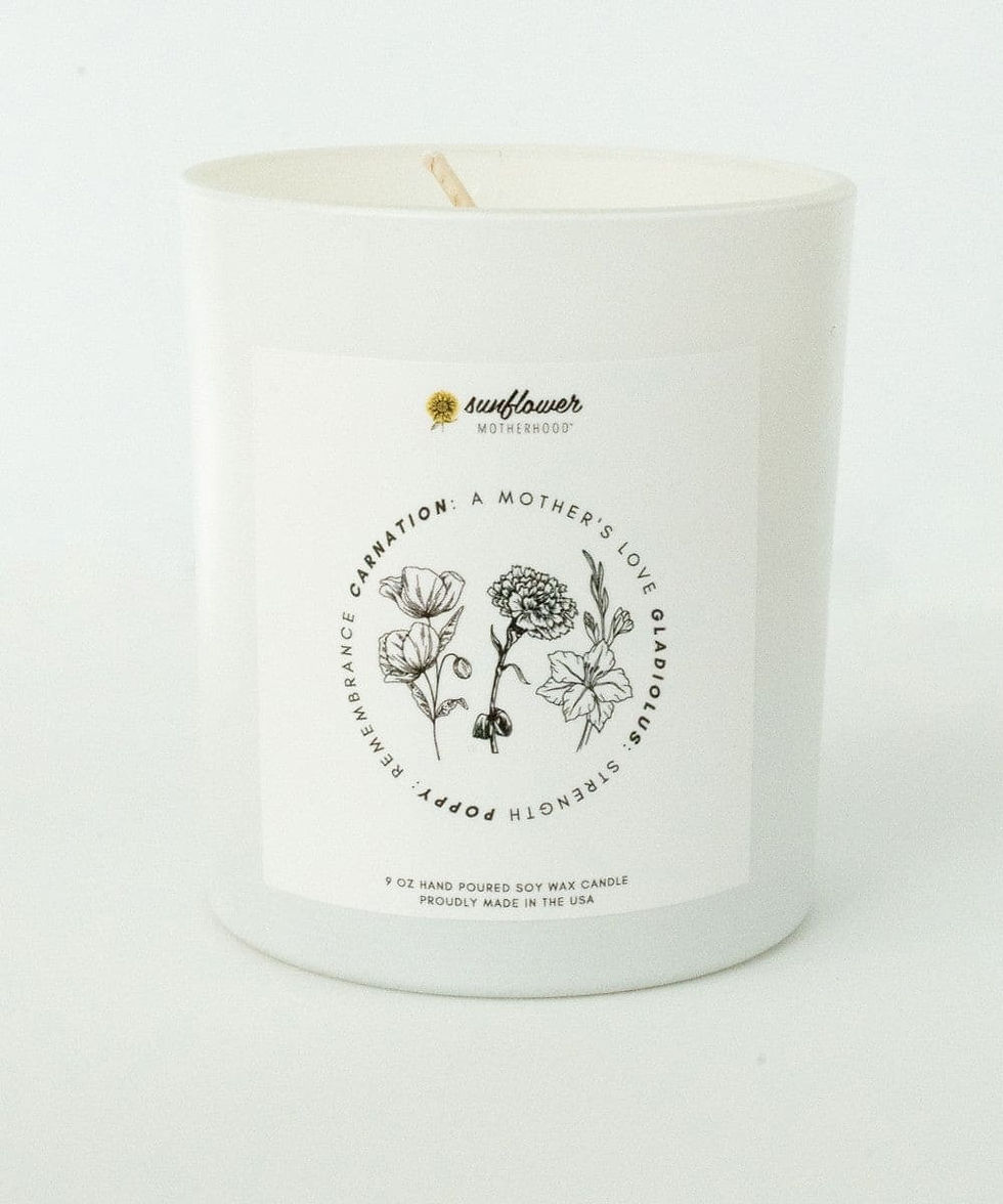 White candle with flower illustrations and label text