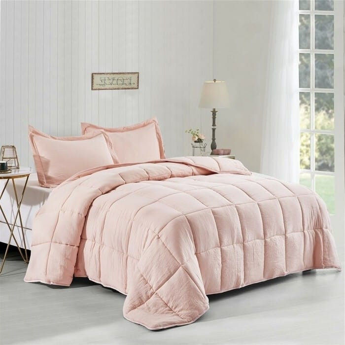 Pink comforter and pillows on a bed