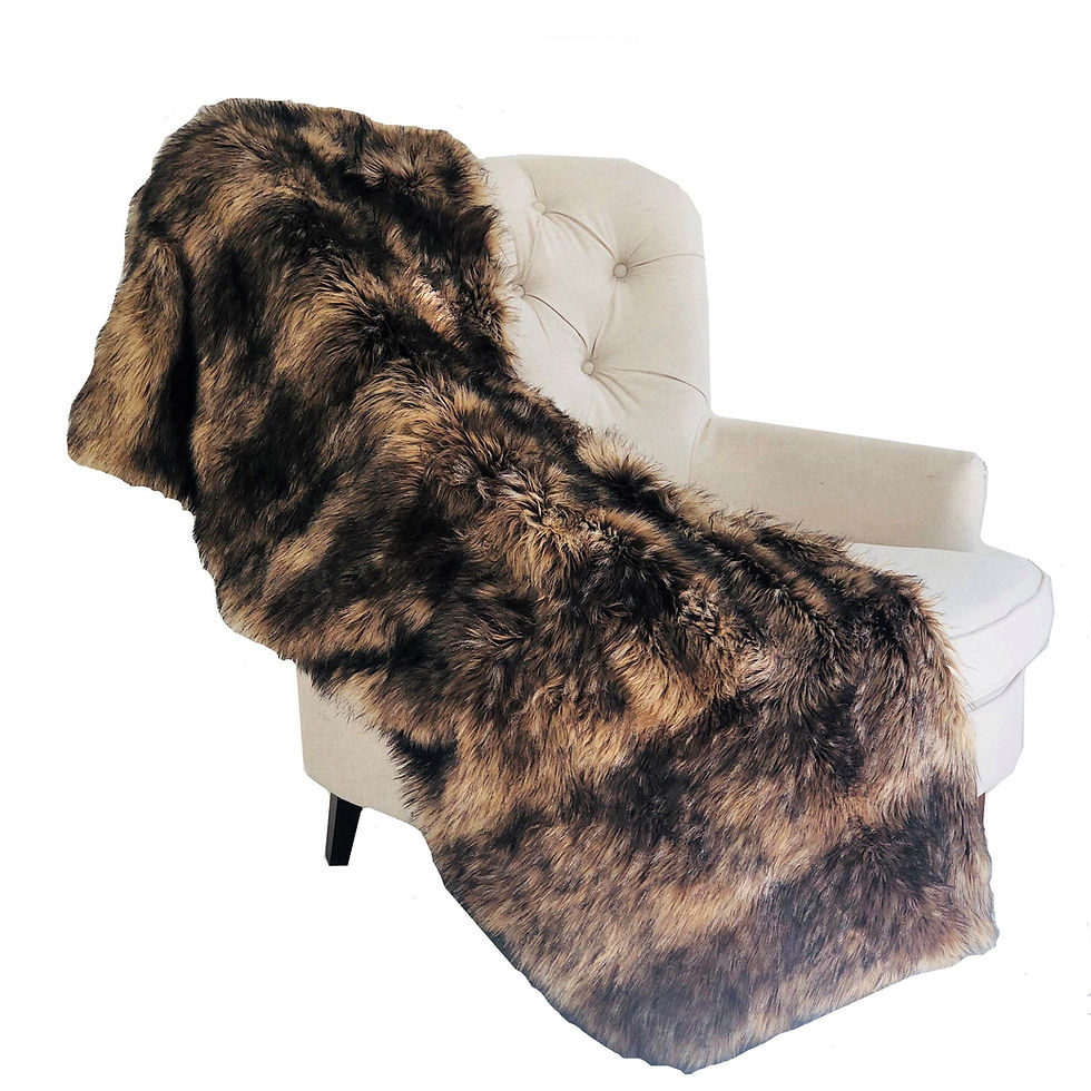 Brown faux fur blanket draped over a white armchair