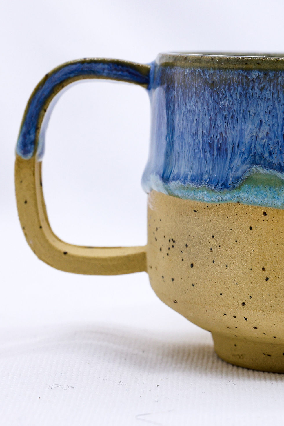 Two-tone blue and beige ceramic mug